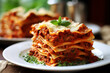 Close-up of a piece of lasagna with meat, cheese and bolognese sauce