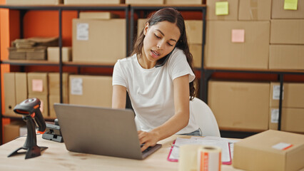 Poster - African american woman ecommerce business worker using computer talking on smartphone at office