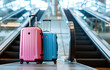 modern two suitcases stand on the metal escalator on blurred white airport background