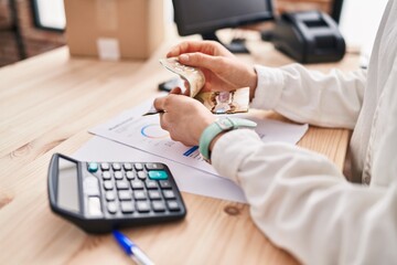 Wall Mural - Young caucasian woman ecommerce business worker counting canada dollars at office