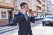 © Krakenimages.com - Young man business worker talking on smartphone drinking coffee at street