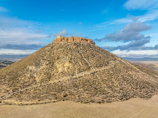 Poster - Aerial view of Castillo de Alcalá or Castillo de La Puebla, Arab castle in Murcia province Spain on top of a flat-top limestone mountain. Large rectangular tower, angled entrance, deep well and cister