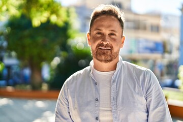 Poster - Young caucasian man smiling confident standing at park