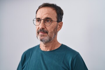 Poster - Middle age man standing with serious expression over isolated white background