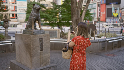 Poster - Beautiful hispanic woman in glasses taking memorable photos at hachiko statue in tokyo's urban cityscape