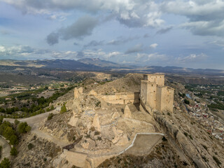 Wall Mural - Aerial panorama view of Castillo de los Velez, medieval ruined castle perched on top of Mula, keep, well tower, machicolation, Parroquia Mayor De Santo Domingo De Guzmán church, 