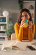 © Zamrznuti tonovi - Young beautiful woman sitting at office desk and enjoying her cup of coffee