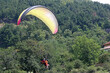 Tandem paraglider coming in to land