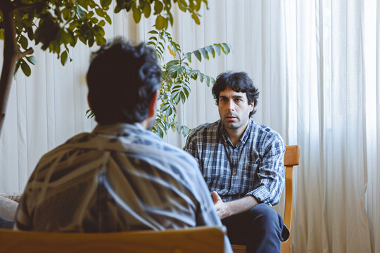 A man talking to his therapist during a therapy session