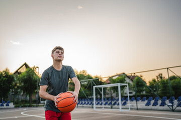 One caucasian teenager stand on basketball court with ball