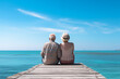 Senior Couple Sits on a Pier by Water