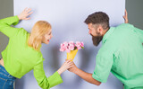 Fototapeta Zachód słońca - Valentines or women's day, anniversary, birthday celebration. Bearded man with bouquet of roses for girlfriend. Smiling man with flowers for beautiful woman. Surprise for girl. Romantic relationships.