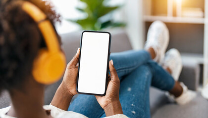 woman with headphones holds mockup smartphone, exuding modernity and connectivity