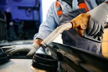 Wall Mural - Close up of driver filling truck fuel tank with gasoline.