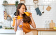 © Art_Photo - Portrait of beauty healthy asian woman making orange fruit smoothie with blender.girl preparing cooking detox cleanse with fresh orange juice in kitchen at home.health, vitamin c, diet, healthy drink