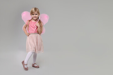 Sticker - Cute little girl in fairy costume with pink wings and magic wand on light grey background, space for text