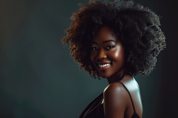 Wall Mural - Smiling young black woman with afro hairstyle in black dress.