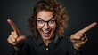 A humorous teacher who wears round glasses and smiles with a stupid face is happy to show something with her pointer on a black chalkboard.