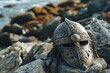 a metal helmet on rocks