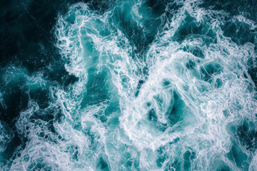 Aerial view of sea waves and foam. The texture of blue ocean.