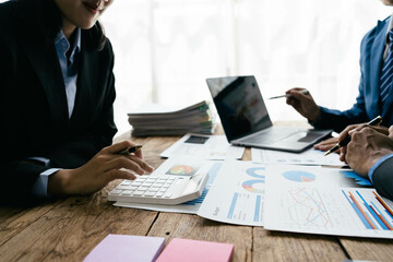 Aufkleber - business people or accountant using calculator while working analytical business report on the workplace, accounting concept, Serious and focused financier accountant on paper work inside office,