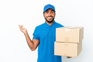 Sticker - Delivery Ecuadorian man isolated on white background extending hands to the side for inviting to come