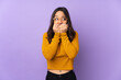 © luismolinero - Young mixed race woman isolated on purple background nervous and scared putting hands to mouth