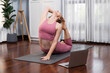 © Summit Art Creations - Flexible and dexterity woman in sportswear doing yoga position in meditation posture on exercising mat at home. Healthy gaiety home yoga online training session with peaceful mind and serenity.