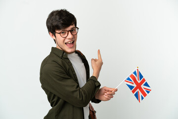 Wall Mural - Young Russian man holding an United Kingdom flag isolated on white background pointing back