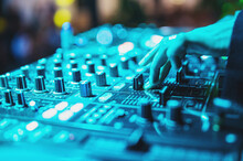 woman DJ Hands creating and regulating music on dj console mixer in concert