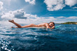 Surf girl relax on surfboard. Naked attractive woman during surfing, surfer in ocean