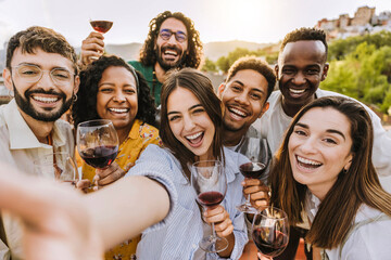 Multiracial friends drinking red wine outside at farm house vineyard countryside - Group of young people taking selfie picture outdoor - Life style concept with guys and girls enjoying summer vacation