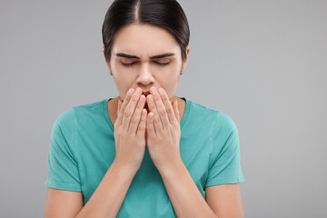 Sticker - Woman coughing on grey background. Cold symptoms