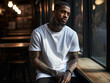 Mockup of a black man with tattoos wearing a white T-shirt