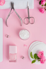 Wall Mural - Salon manicure concept photo. Manicure equipment with nail polish and rose petals pink background top view space for text