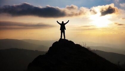 silhouette of a man on top who has reached the top of the mountain 