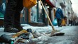Street sweeper cleans the sidewalk with a broom in the city