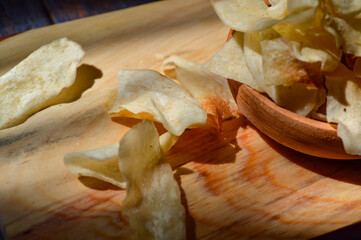 Wall Mural - Keripik talas or taro chips is made of deep fried thin slice taro . Crispy savory snack. Typical Indonesian traditional chips.