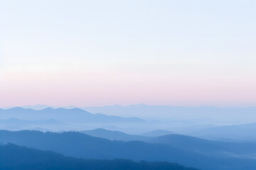 Wall Mural - Mountain rock, sunset and snow fog