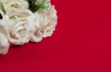 Bouquet of white roses on a red background with copy space