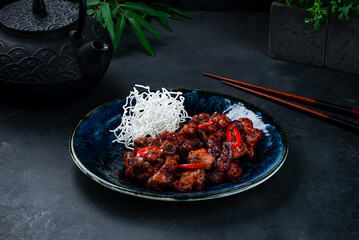 Wall Mural - Pork in Thai sweet chili sauce on a dark background.