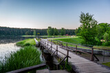 Fototapeta Pomosty - A wooden pathway trail with the bridge during in the old park along the lake Vidusezers in Smiltene, Latvia.