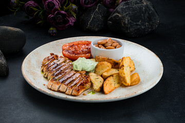 Wall Mural - Fried chicken fillet with rustic potato wedges, beans, tomatoes and sauce.