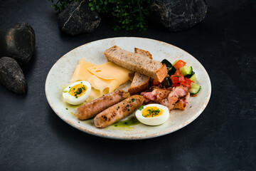 Poster - English cuisine breakfast sausages, bacon, eggs, cheese, vegetable salad, bread and sauce.