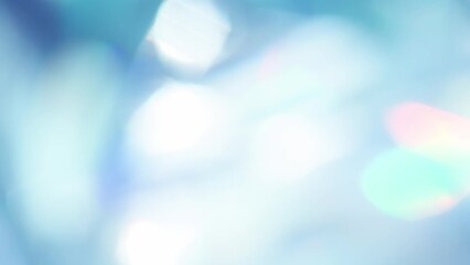 Wall Mural - Iridescent Flares and Blue Shimmers. Loop. The light passes through the facets of a slowly rotating diamond and creates repetitive sparkling highlights and rainbow colors