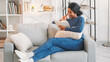 © golubovy - Literature leisure. Reading hobby. Book weekend. Joyful young woman enjoying interesting novel story indoors relaxing on comfy couch in living room at home.