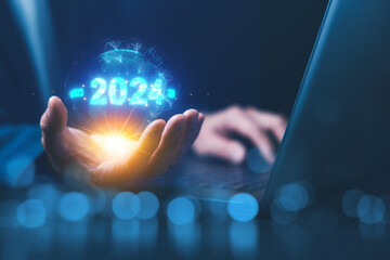  - 2024 business world concept. Businessman using computer laptop and holding Global network connection. New year business startup and Goals target, Opportunity.