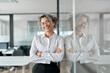 © insta_photos - Happy middle aged professional business woman standing in office, portrait. Smiling mature senior female corporate leader, confident lady executive manager arms crossed looking at camera.
