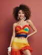 © OlScher - A woman with curly hair, wearing a colorful outfit and big earrings, smiles at the camera.