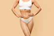 © Prostock-studio - Toned young woman in white underwear standing with hands on waist